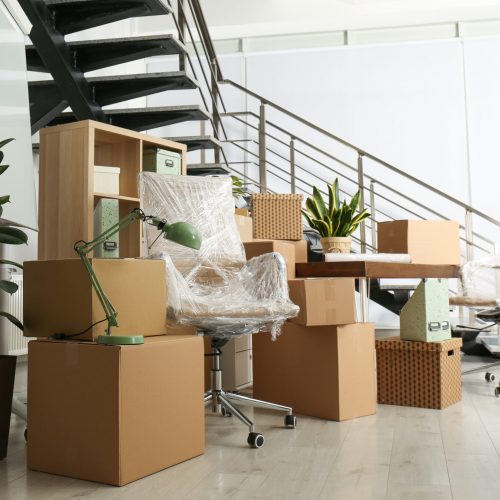 Cardboard,Boxes,And,Furniture,Near,Stairs,In,Office.,Moving,Day